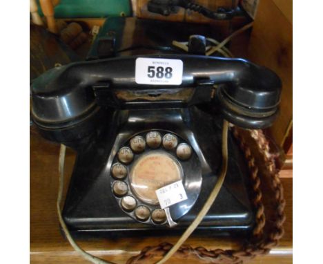 A vintage black Bakelite telephone - sold with its switchbox