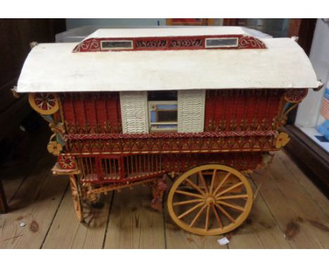 A large vintage scratch built wooden gypsy wagon with decorative detailing to exterior and interior