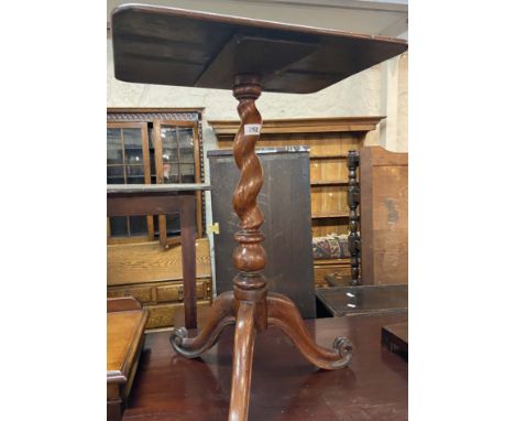 A Victorian stained walnut pedestal wine table with oblong top, set on barley twist pillar and tripod base