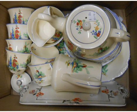 An Art Deco Midwinter pottery part tea set decorated with a colourful transfer print of a windmill and garden