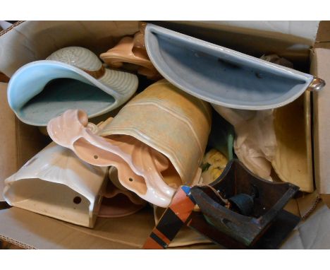 A box containing a quantity of ceramic wall pockets