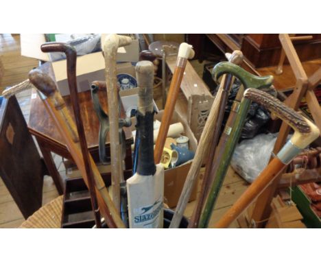 A selection of walking sticks and other items including horn handled dated 1888, old shooting stick, cricket bat, etc.