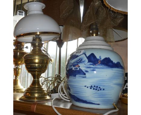 An antique Chinese blue and white ginger jar converted to a lamp - sold with an old brass oil lamp with chimney and opaque wh