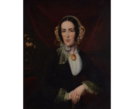 19th Century English School - Oil on canvas - Half length portrait of a seated lady wearing a floral pace cap and black dress