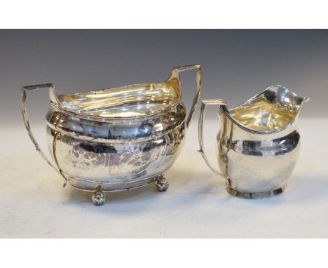 George III silver helmet shaped cream jug, London 1805, together with a Georgian silver two handled sugar basin, hallmarks in