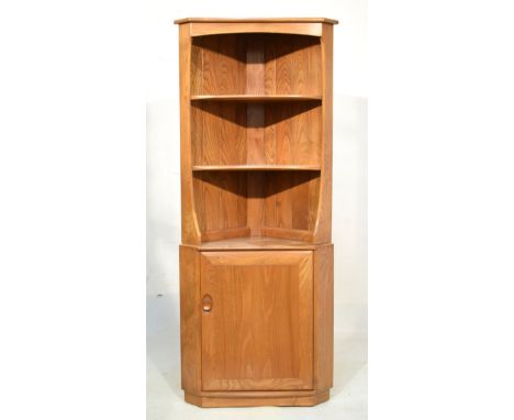 Ercol 'Golden Dawn' elm floor standing corner unit having open section on cupboard base   Condition: 