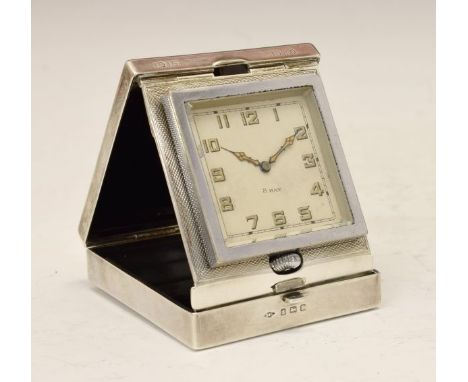 George V engine turned silver cased travel alarm clock, the off-white dial with Arabic numerals, Birmingham 1935, 18.25cm x 1