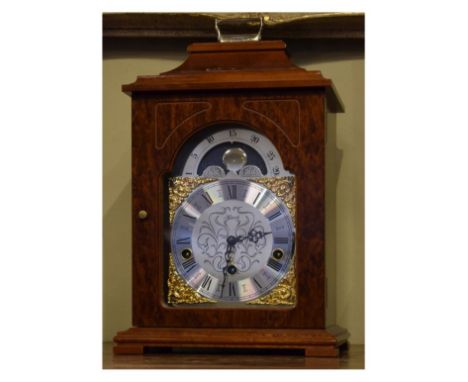 Reproduction mahogany finish cased mantel clock by Franz Hermle, having a brass and silvered dial with moon phase to the arch