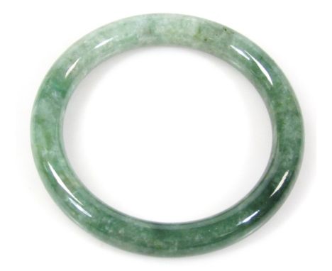 A 20thC Peking green glass jade coloured bangle, of circular outline in fitted case, with David Tong card, 9cm dia.
