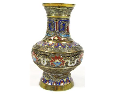 A 20thC champleve enamel and brass vase, of bellied outline with trumpet stem on circular foot, raised with a central floral 