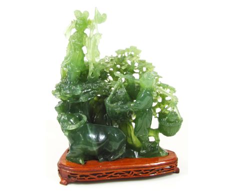 A 20thC spinach jade carving, formed as a figure with garland and birds, on a naturalistic setting above a further figure hol