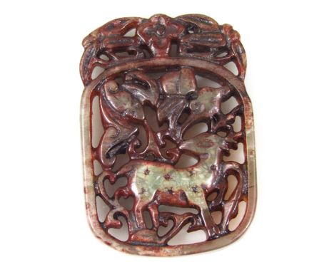 A 19thC Chinese jade buckle, of shaped outline surmounted by flowerheads and centred by a carved scene of a stag in a natural