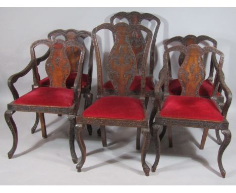 A set of six early 20thC Chinese carved dining chairs, with heavy scroll top rails, hour glass splats, shaped arms and drop-i
