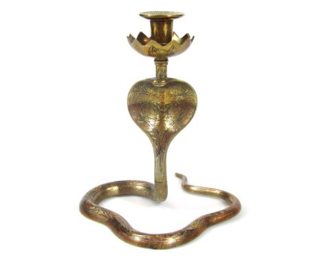 An early 20thC brass candlestick, the floral dish holder on cobra stem, profusely decorated with flowers, unmarked, 22cm high