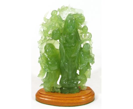 A modern carved green jade style figure group of hotei, Bodhisattva and others, on a wooden plinth stand, 29cm high.