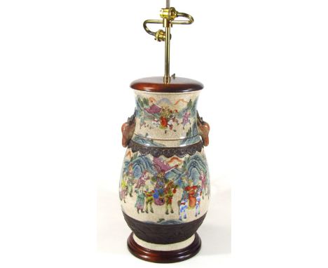 A Chinese crackle glazed pottery table lamp, with modern fittings, the bulbous body heavily decorated with figures in a natur