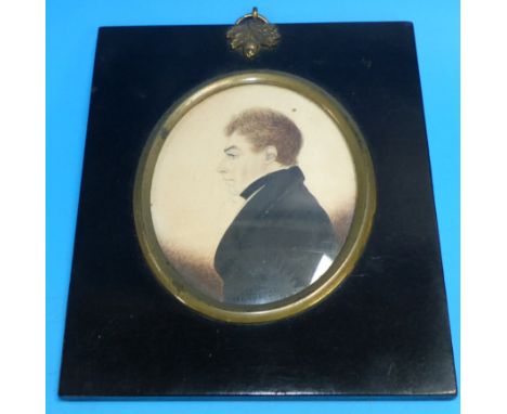 A 19th century miniature portrait on paper of a young man, ebonised frame with gilt metal mounts, 5¼ x 4¼ overall