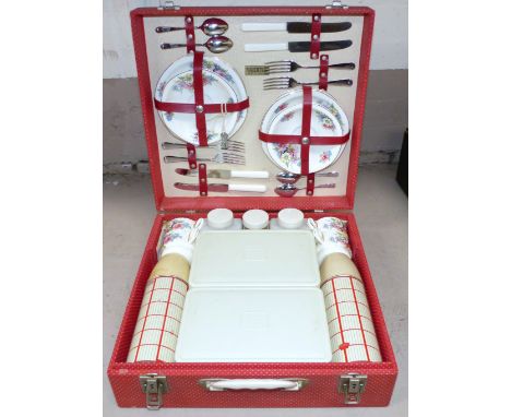 A Brexton picnic set, unused with original fittings and floral decorated cups and saucers