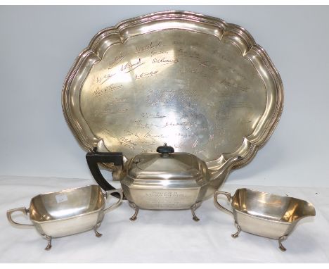 A 1930's neo-Georgian style 3 piece tea service with corner panels of engraved decoration, the teapot bearing inscription:  "