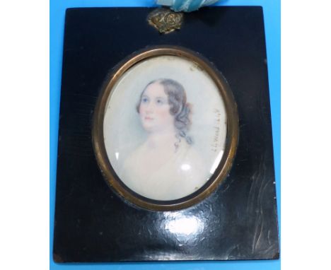 A 19th century miniature portrait on ivory of a young woman, signed L.L. Wood 1848, ebonised frame with gilt metal mounts, 5½
