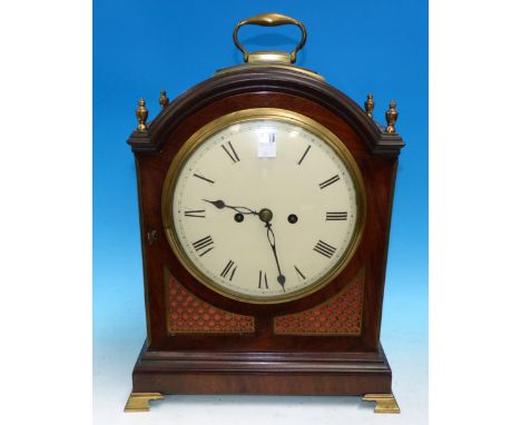 A mid George III arch top mahogany bracket clock with brass ring handle on brass mounted pad top, 4 turned vase finials, reed