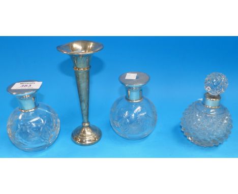 A pair of globular cut scent bottles with engine turned tops (1 a.f.); a similar scent bottle; a silver specimen vase