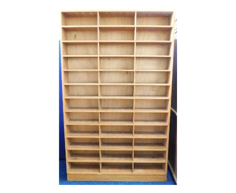 A substantial pine former post office pigeon hole sorting shelf unit, 81.75in high x 50.5in wide x 8in deep