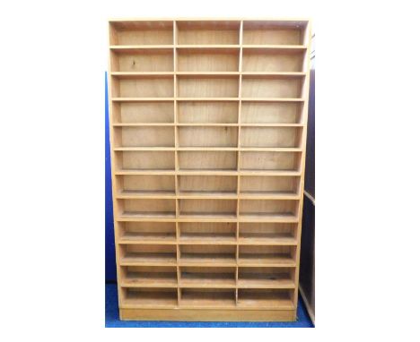 A substantial pine former post office pigeon hole sorting shelf unit, 81.75in high x 50.5in wide x 8in deep