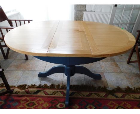 Tremaine Manor House: An as new, modern extending light oak dining table, 57in wide x 43.25in deep x 30.25in high