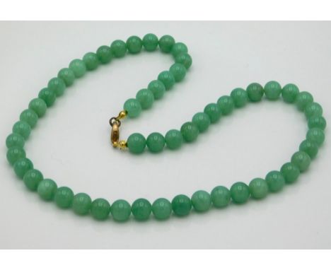 A jade necklace measuring 18in long, beads 8mm, 44.1g