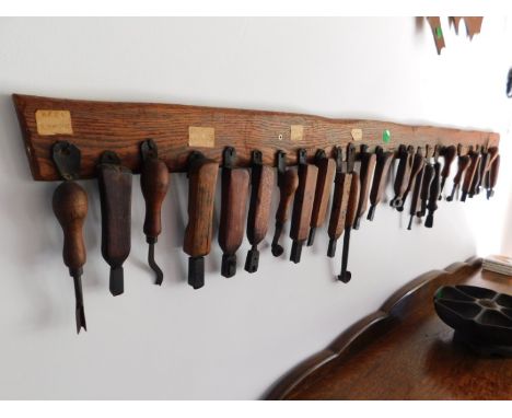 Cobbler's Cottage: An oak rack of twenty six leather worker & cobblers tools, rack measures 57in