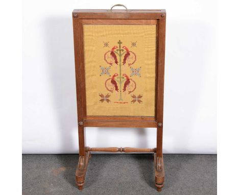 An Edwardian stained beech and mixed wood fire screen, rectangular wool-work panel, width 44cm, minimum height 95cm.