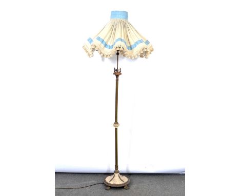 Gilt metal standard lamp, fluted column with adjustable section, designed with a marble knop, domed marble base on lion paw f