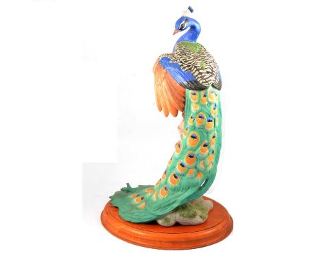 A Franklin Fine Porcelain model, The Royal Peacock, For The Royal Society of The Protection of Birds, on a wooden stand, 58cm