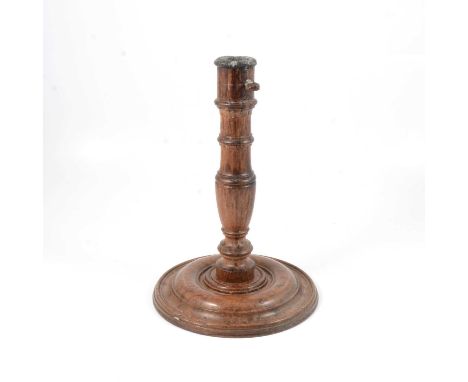 An old oak candle stick, turned column, circular base, 31cm.