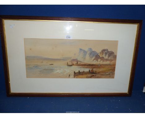 A framed and mounted Watercolour depicting a seascape with boats, figures and rugged cliffs, signed lower right 'W.H. Vernon'