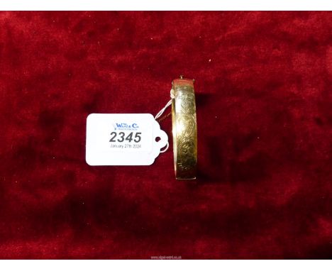 A plated 1/5th 9ct gold metal core Bangle with engraved foliate design.