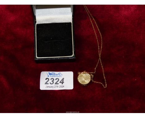 A circular engine turned 9ct gold back and front locket on 9ct gold chain.