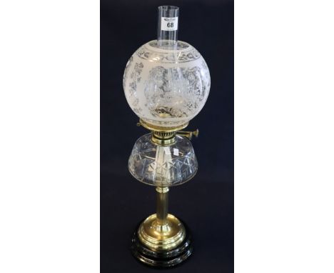 Early 20th Century brass double burner oil lamp with clear cut glass reservoir, brass pedestal and ceramic base, etched glass