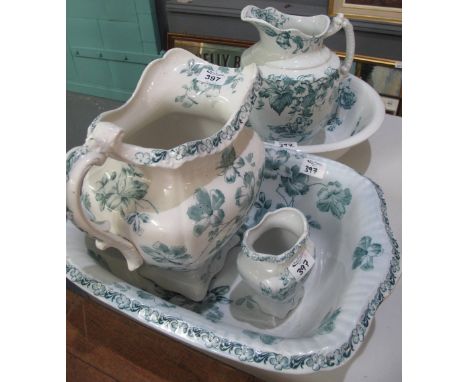 'Lily' transfer printed jug and basin set, together with a similar three piece jug and basin set with toothbrush holder. (5)(