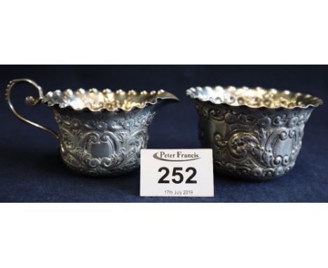 Repousse silver cream jug with crimped edge and loop handle, together with matching sucrier. London hallmarks. 3.5 troy ozs a