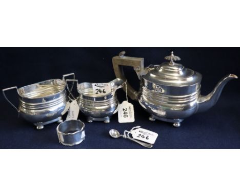 Silver three piece bachelor's tea service of baluster form on bun feet, with engraved monogram and date July 1911. London hal