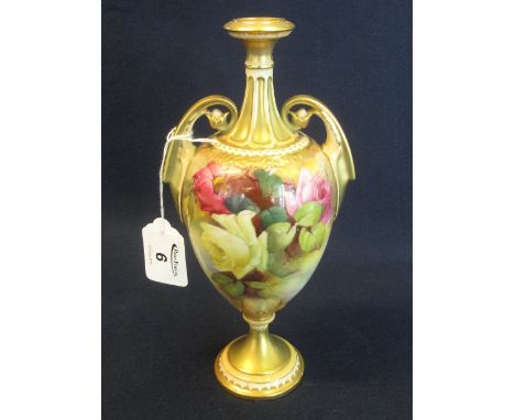 Royal Worcester porcelain two handled vase of ovoid form hand painted with roses and foliage, standing on a gilded circular s