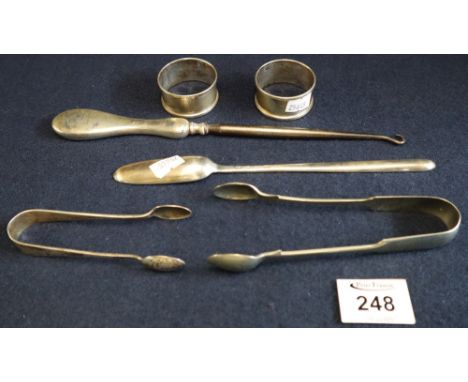 Bag of odd silver and other items to include; silver handled button hook, silver stilton scoop, napkin rings, sugar tongs etc