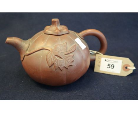 Chinese Yixing teapot of melon shape with loop handle and relief leaf decoration. Flower head mark to base and shaped top. 4c