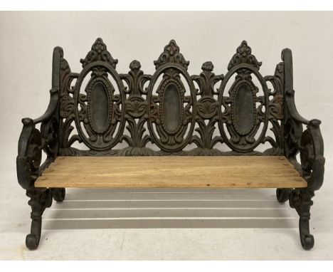 A TABLE TOP CAST VICTORIAN STYLE BENCH WITH WOODEN SLATTED SEAT 