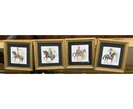 A SET OF FOUR GILT FRAMED CAVALRY DESIGN TILE PICTURES 