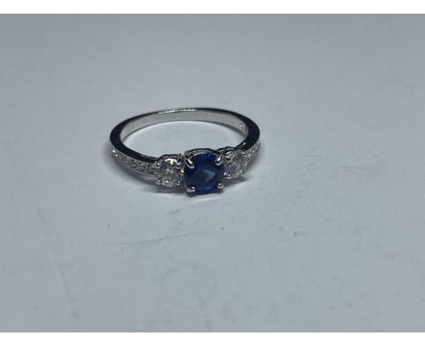 A SWAROVSKI RING WITH BLUE AND CLEAR CRYSTALS WITH LABEL, PRESENTATION BOX AND SLEEVE SIZE K/L 