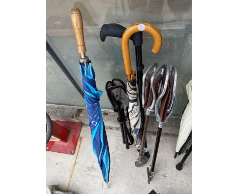 AN ASSORTMENT OF UMBRELLAS, WALKING STICKS AND STICK SEATS ETC 