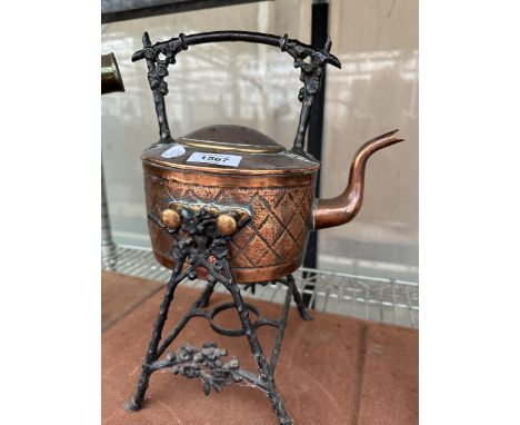 A VINTAGE COPPER KETTLE WITH A CAST CANDLE HOLDER STAND 